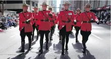  ??  ?? Mounties march in their red-serge dress uniforms during the Calgary Stampede parade in Calgary in 2013.