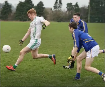  ??  ?? Ben Moore evades Wicklow Schools duo Tom Maher and Jacques McCall.