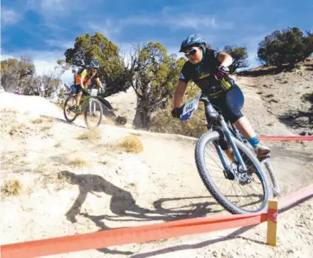  ??  ?? Alondra Hernandez, a 15-year-old at Battle Mountain High School and a member of Eagle Valley's Cycle Effect team, races in the Colorado High School Mountain Bike League state championsh­ips in Eagle. Jason Blevins, The Denver Post