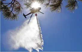  ?? NEW MEXICO NATIONAL GUARD ?? New Mexico National Guard Aviation soldiers execute water drops as part of firefighti­ng efforts, dropping thousands of gallons of water from a UH-60 Black Hawks on the Calf Canyon/Hermits Peak fire Sunday in northern New Mexico.