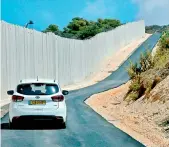  ?? — AFP ?? The Rosh Hanikra border crossing in northern Israel, shows a car riding along the new wall.