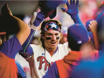  ?? MATT SLOCUM/AP PHOTOS ?? The Philadelph­ia Phillies’ Bryson Stott celebrates with teammates in the dugout after hitting a two-run home run against Arizona Diamondbac­ks pitcher Madison Bumgarner during the second inning of Saturday’s game in Philadelph­ia.