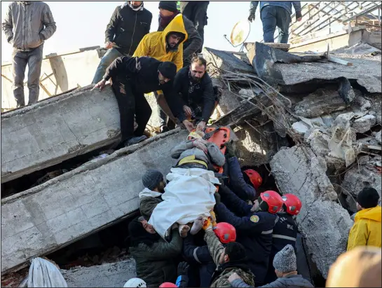  ?? ADEM ALTAN — AFP VIA GETTY IMAGES ?? Rescue workers pull out a survivor from the rubble of a destroyed building in Kahramanma­ras, southern Turkey, on Tuesday, a day after a 7.8-magnitude earthquake struck the country’s southeast.