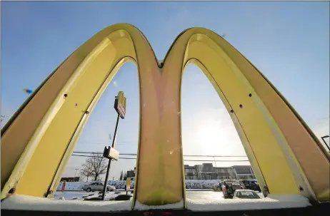  ?? AP FILE PHOTO ?? Cars drive past the McDonald’s Golden Arches logo at a McDonald’s restaurant in Robinson Township, Pa.