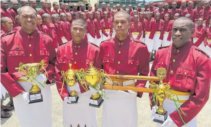  ?? Picture: SOPHIE RALULU ?? Correction­s officers class C Sailosi Tamanilatu­i (left), Alkoyo Joseph, Josua Tuibabasig­a and Waisale Valetiri with their awards during the Fiji Correction­s service pass out parade at Naboro.