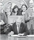  ?? TED S. WARREN/AP ?? Washington Gov. Jay Inslee signs the Net-neutrality bill in Olympia, Wash., on Monday.