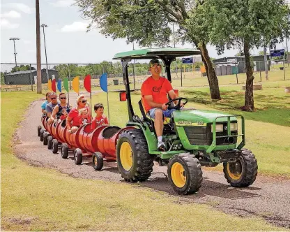  ?? [PHOTOS BY THOMAS MAUPIN, FOR THE OKLAHOMAN] ?? Dean Stone, of the Cornerston­e Kids’ Ranch of Ada, drives the Happy Train in Buck Thomas Park.