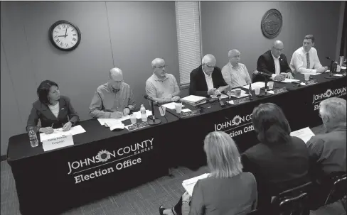  ?? The Associated Press ?? PRIMARY: Board of County Commission­ers chairman Ed Eilert, center, speaks during the Johnson County Board of Canvassers meeting, Monday in Olathe, Kan. County election officials across Kansas on Monday began deciding which provisiona­l ballots from last week’s primary election will count toward the final official vote totals, with possibilit­y that they could create a new leader in the hotly contested Republican race for governor. Secretary of State Kris Kobach led Gov. Jeff Colyer by a mere 110 votes out of more than 313,000 cast as of Friday evening.