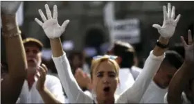  ?? EMILIO MORENATTI — THE ASSOCIATED PRESS ?? People raise their hands painted in white during a protest in favor of talks and dialogue in Sant Jaume square in Barcelona, Spain, Saturday.