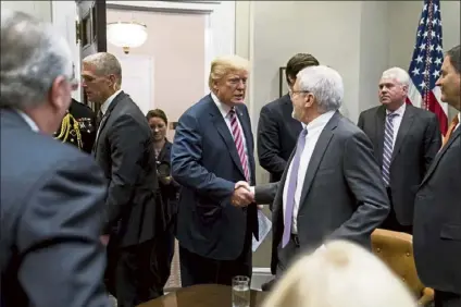  ?? The new york times File PHOTO ?? president donald trump at a meeting with business leaders about tax reform in the Roosevelt Room of the White House in Washington in 2017. From the start of trump’s presidency, corporate america has vacillated between supporting his economic agenda and condemning his worst impulses.