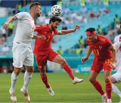  ??  ?? Switzerlan­d's Haris Seferovic, left, and Wales' Joe Allen go for a header during the Euro 2020 soccer championsh­ip group A match between Wales and Switzerlan­d