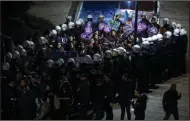  ?? (AP/Kemal Aslan) ?? Riot police surround a group of women protesting Friday to mark the Internatio­nal Day for the Eliminatio­n of Violence Against Women, in Istanbul, Turkey.