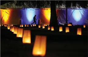  ?? ?? A person walks outside a World Aids Day commemorat­ion event at The Wall Las Memorias Monument in Los Angeles, California