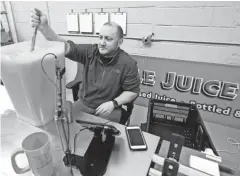  ?? MIKE DE SISTI / MILWAUKEE JOURNAL SENTINEL ?? Jason Lannoch, Juiced! founding owner, works on testing juice for the correct pH level at the company’s new site on S. 5th St. in Walker’s Point.