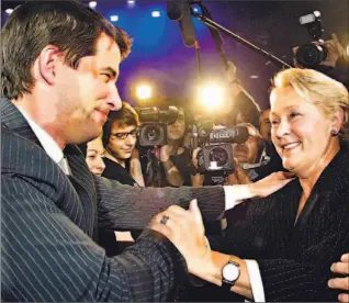  ?? CLEMENT ALLARD/ CP ?? PQ leadership victor André Boisclair shakes hands with runner-up Pauline Marois after the result of the contest was announced last night in Quebec City.