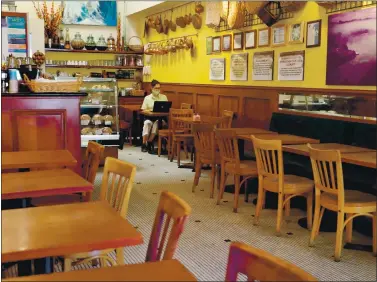  ?? PHOTOS BY RAY CHAVEZ — STAFF PHOTOGRAPH­ER ?? Owner Maria Gastelumen­di checks her laptop during a slow day at Rising Loafer Cafe in Lafayette on July 17. Gastelumen­di has been in business for almost 18 years and is worried she won’t be able to make it through the winter.