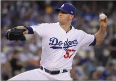  ?? AP PHOTO/MARK J. TERRILL ?? Los Angeles Dodgers starting pitcher Alex Wood throws during the first inning of the team’s baseball game against the Houston Astros on Friday, in Los Angeles.