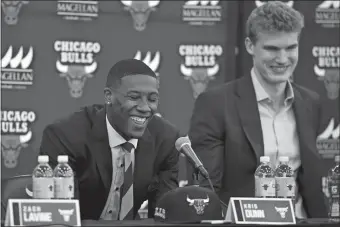  ?? G-JUN YAM/AP PHOTO ?? Kris Dunn, left, and Lauri Markkanen laugh at a question during a news conference at the the Bulls’ training facility on Tuesday, where Dunn, Markkanen and Zach LaVine were introduced.