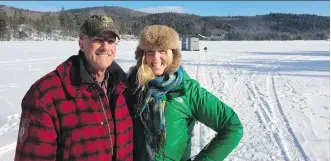  ?? CHRIS ROVZAR/ THE ASSOCIATED PRESS ?? Kelly Will poses in Stoneham, Maine, with Rod Rovzar, who took her ice fishing. Will visited Stoneham as part of a year-long trip to see the 50 states, a trend that is growing in the U.S.