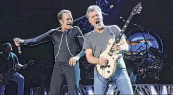  ?? Greg Allen / Associated Press ?? David Lee Roth, left, and Eddie Van Halen of Van Halen perform in Wantagh, Long Island, in 2015. Van Halen, who had battled cancer, died Tuesday at age 65.