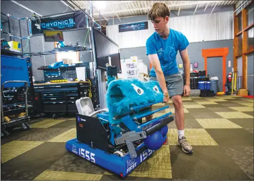  ?? (Ap/south Bend Tribune/michael Caterina) ?? Weston Markham demonstrat­es Aug. 10 a robot he helped design at E3 Robotics Center in Elkhart, Ind. Markham, a 16-year-old high school student, said he loved playing with Legos as a kid and has enjoyed building things for as long as he can remember.