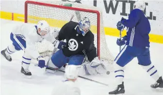  ?? CHRIS YOUNG, THE CANADIAN PRESS ?? Maple Leafs goaltender Frederik Andersen makes a stop against Tyler Bozak during practice on Monday as the team prepares to face the Boston Bruins.