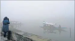  ?? PTI ?? People ride shikaras in Dal Lake on a cold foggy morning in Srinagar on Sunday.