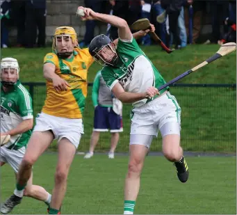  ??  ?? M.J. Furlong (Cloughbawn) beats Podge Doyle (Shamrocks) to the ball with a spectacula­r leap.