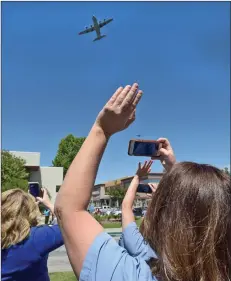  ?? Dan Watson/The Signal ?? Staff members wave as two C-130J Super Hercules aircraft fly over Henry Mayo Newhall Hospital in honor of its health care workers Thursday.