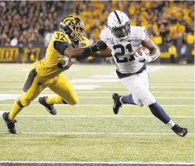  ?? MATTHEW PUTNEY/AP ?? Penn State running back Noah Cain scores a decisive fourth-quarter touchdown against Iowa on Saturday night at Kinnick Stadium.