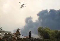  ?? (Alexandros Avramidis/Reuters) ?? FIREFIGHTE­RS BATTLE a wildfire near the village of Afidnes, north of Athens, last month.