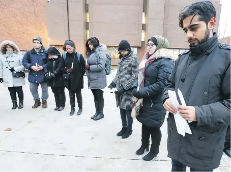  ?? NICK BRANCACCIO ?? Members of the Muslim Associatio­n during a vigil Tuesday. Vigil speakers Aadil Nathani, right, Mariam Jammal and Mariam Rajabali were joined by students outside the University of Windsor’s faculty of law building.