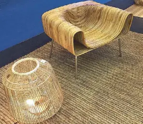  ??  ?? Armchair in rattan and metal by Finali, floor lamp in bamboo by Basket &amp; Weaves, abaca carpet by WeaveManil­a