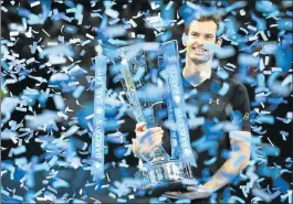  ??  ?? ANDY MURRAY – holds the spoils of war on his way to the summit of tennis