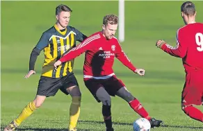  ??  ?? Bank Street Athletic (red) came out on top of Stobswell Athletic in a fivegoal match at Drumgeith.