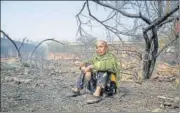  ?? SANCHIT KHANNA/ HT ?? A local resident sits outside her burnt down home in Sanjay Colony in Okhla Phase 2 on Sunday.