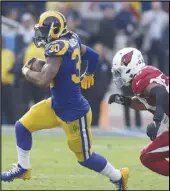  ?? KEVIN REECE Special to the Valley Press ?? GETTING AWAY
Rams running back Todd Gurley (30) runs away from the Cardinals’ Jordan Hicks during Sunday’s game in Los Angeles. Rams GM Les Snead said he thinks Gurley can be better.
