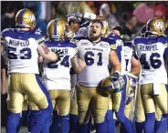  ?? THE CANADIAN PRESS/JUSTIN TANG ?? Winnipeg Blue Bombers’ Matthias Goossen (61) celebrates the team's game winning field goal against the Ottawa Redblacks during second half of a CFL football game in Ottawa on Friday.