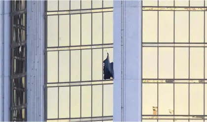  ?? Picture / AP ?? A broken window at the Mandalay Bay resort is in one of the two rooms the gunman fired from.