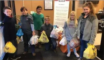  ?? / Contribute­d ?? Students from Fairmount Elementary helping the Voluntary Action Center with their annual Fired Up Food Drive, which provides around 80 percent of the food in their kitchen.