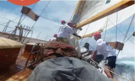  ?? ?? Below: A yacht plunging through the deep blue swells at Antigua Classic Yacht Regatta