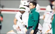  ?? Ethan Hyman / Associated Press ?? Miami coach Manny Diaz watches his players warm up for a game against NC State on Nov. 6.