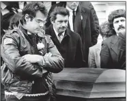  ??  ?? Pallbearer Dan Aykroyd walks beside the coffin of his friend and creative collaborat­or John Belushi following funeral services at West Tisbury Congregati­onal Church on Martha’s Vineyard, Maine, March 10, 1982.