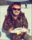  ?? John Hayes/Post-Gazette ?? Gary Walsh of McKeesport pulled a fat 16-inch rainbow trout through the ice Feb. 2 at Twin Lakes.