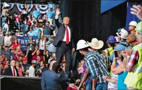  ?? CAROLYN KASTER/AP PHOTO ?? President Donald Trump waves to the cheering crowd as he leaves a rally at the Four Seasons Arena at Montana ExpoPark on Thursday in Great Falls, Mont., in support of Rep. Greg Gianforte, R-Mont., and GOP Senate candidate Matt Rosendale.