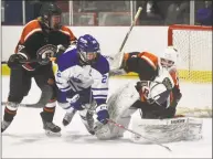  ?? Dave Stewart / Hearst Connecticu­t Media ?? Ridgefield goalie Sean Gordon makes a save as Darien’s Hudson Pokorny (21) and Ridgefield’s Patrick Rigby battle in front on Saturday.