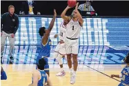  ?? MICHAEL CONROY/ASSOCIATED PRESS ?? Gonzaga guard Jalen Suggs shoots over UCLA guard David Singleton to win the game during overtime in a Final Four game on Saturday. Gonzaga won 93-90.