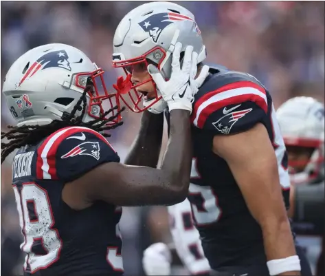  ?? STAFF PHOTO — NANCY LANE/BOSTON HERALD ?? New England Patriots tight end Hunter Henry, right, celebrates his touchdown with Rhamondre Stevenson during the second quarter of a season-opening game against the Philadelph­ia Eagles at Gillette Stadium in Foxboro.