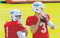  ?? MIKE STOCKER/SUN SENTINEL ?? Dolphins quarterbac­ks Tua Tagovailoa and Josh Rosen throw the ball during training camp Friday at Doctors Hospital Training Facility at Nova Southeaste­rn University in Davie.