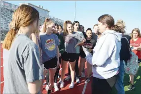  ?? TIMES photograph by Annette Beard ?? Track coach Heather Wade talks to her team Monday before they begin practice. Wade has led the Blackhawk track team to numerous titles since taking on the track and cross country coaching position.